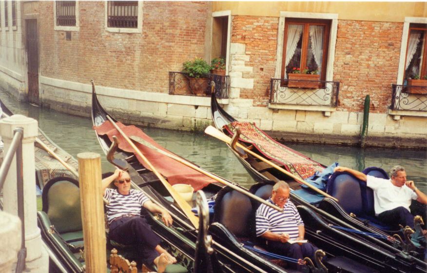 Photo: Gondoliers relax before the tourist rush hour