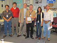 Mike Davison receives the NCEP  
       Isaac Cline award for his Outreach efforts from NCEP Director Louis Uccellini.